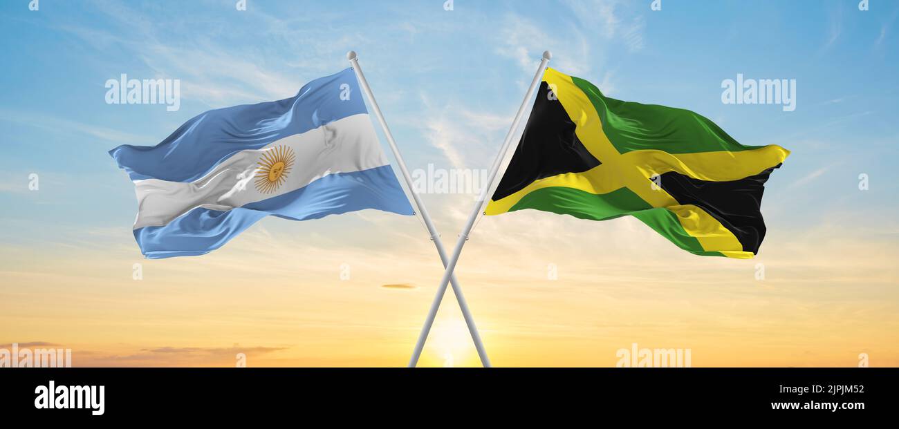 crossed national flags of Argentine and Jamaica flag waving in wind at ...
