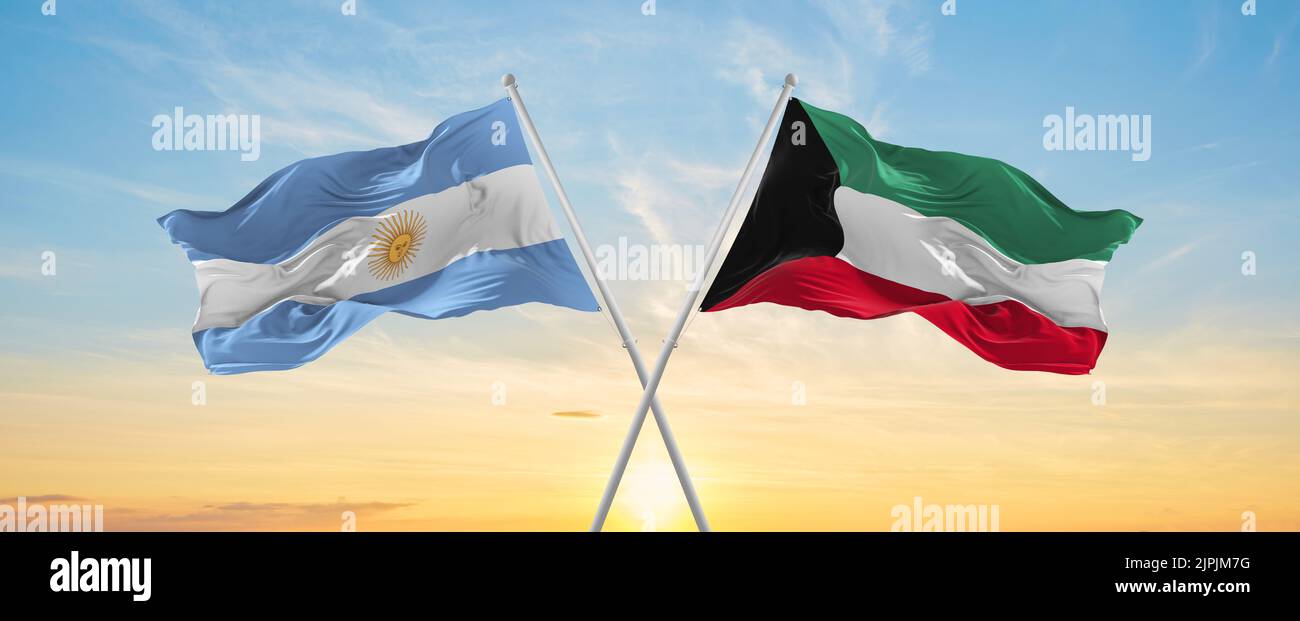 crossed national flags of Argentine and Kuwait flag waving in wind at ...