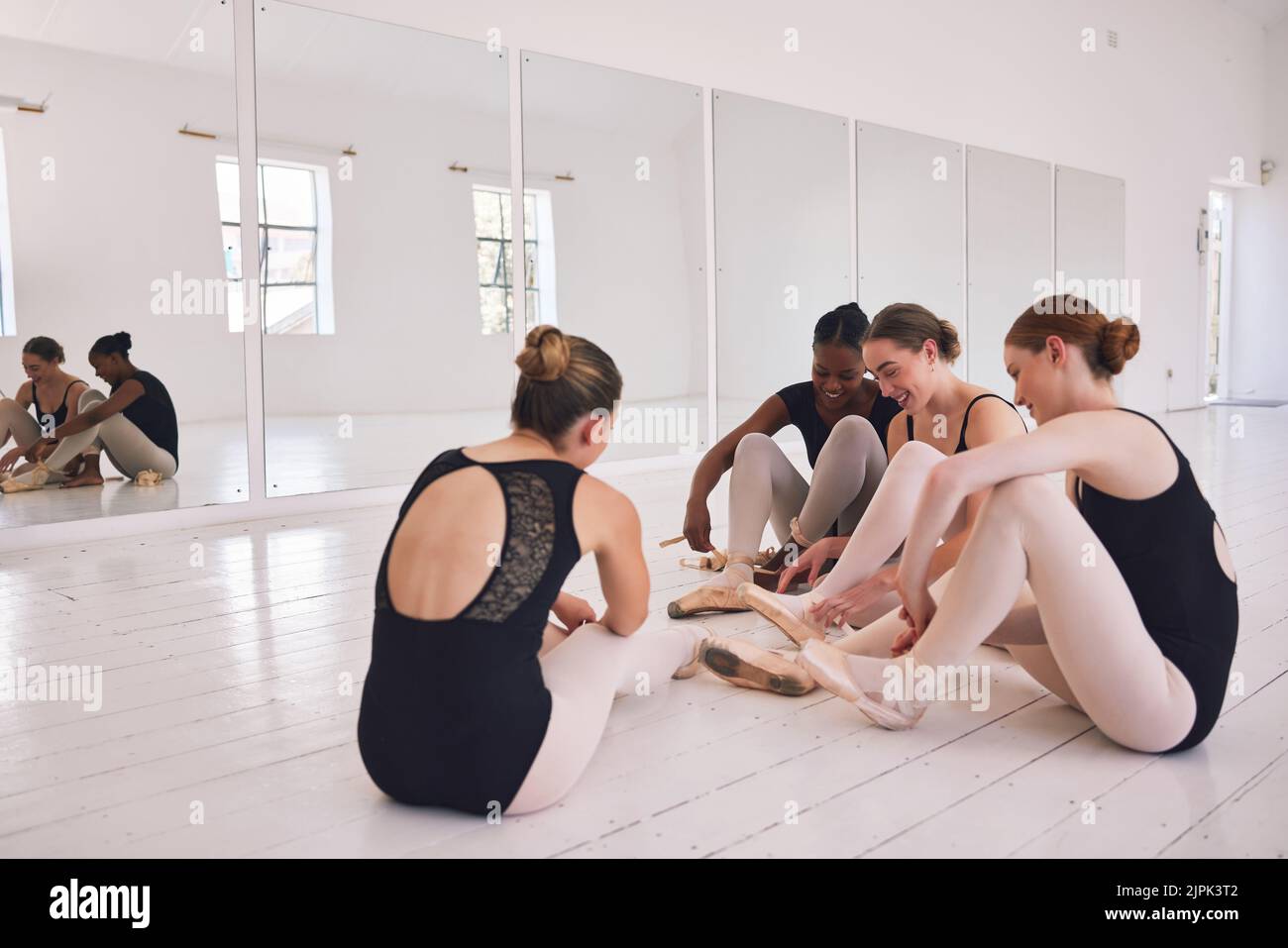 Group of female ballet dancers getting ready or dressing in a ballet