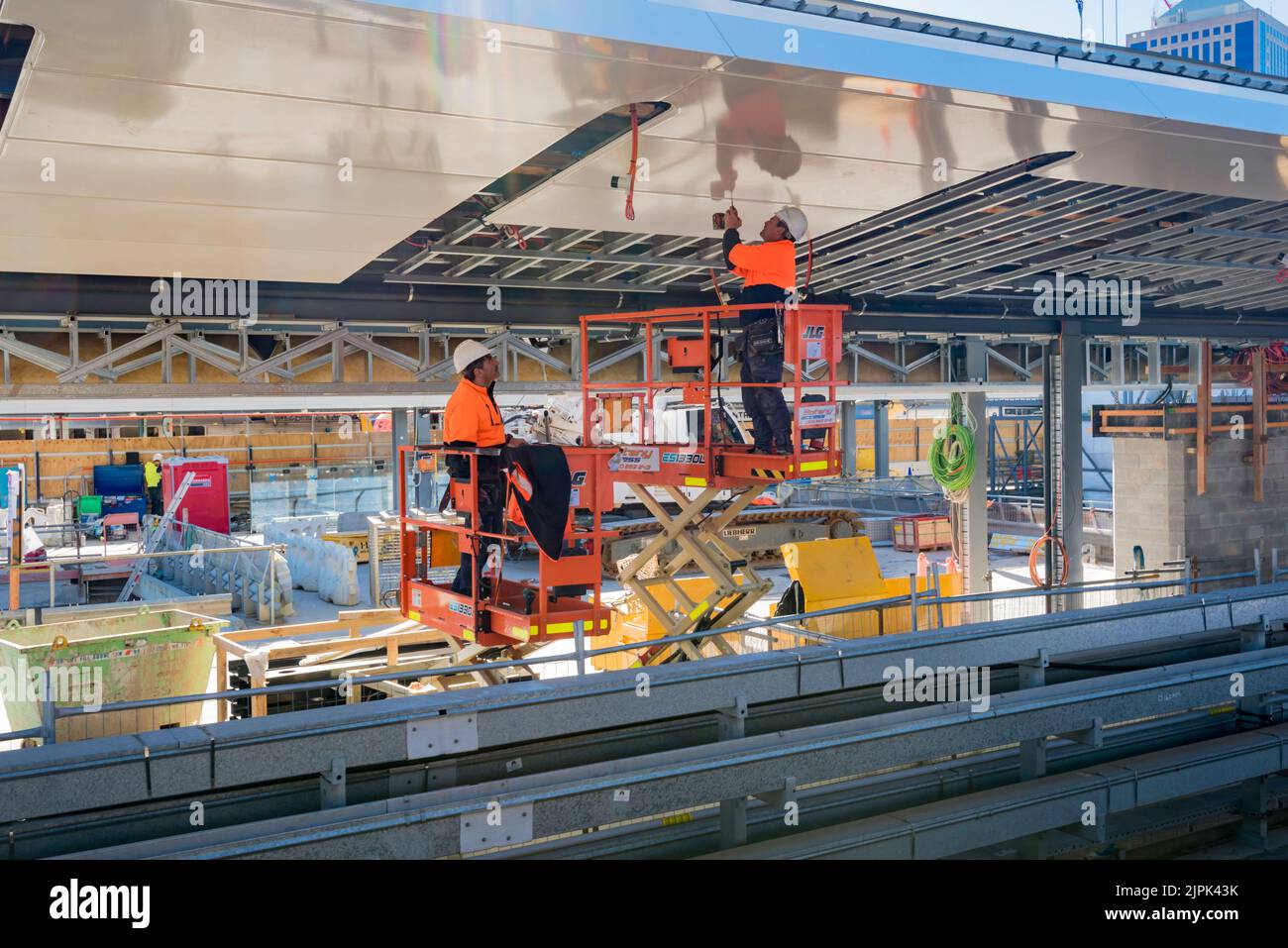 June 8th 2022: People working on the roof of the new Metro railway platforms at Central Station in Sydney, Australia in high visibility safety PPE. Stock Photo
