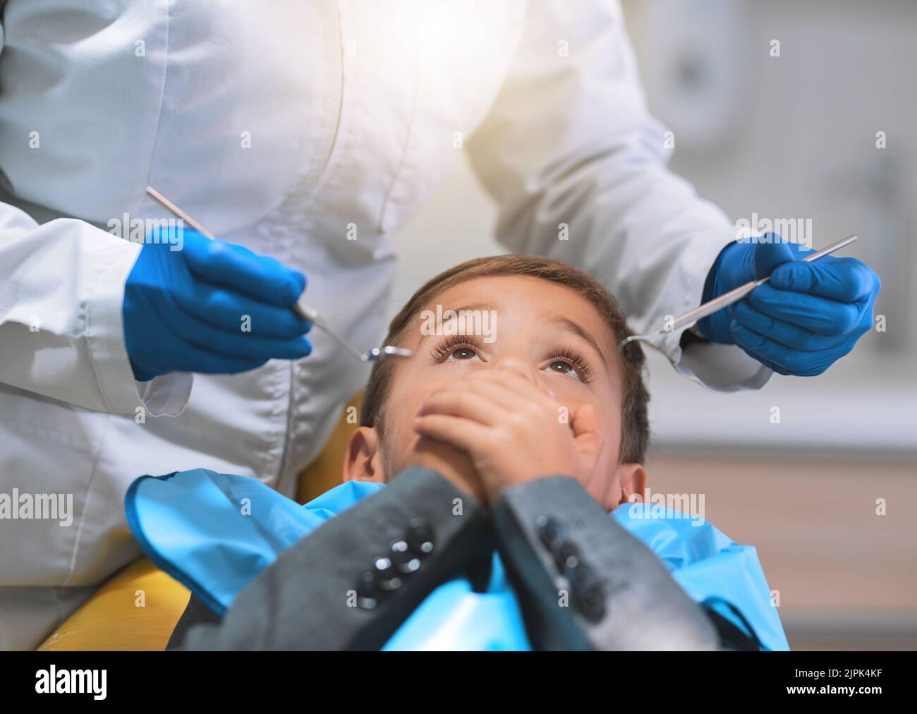 Do you promise that it wont hurt. a frightened little boy lying down on