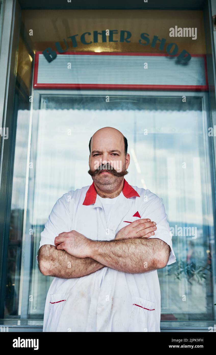 Ive always wanted my own butcher and now I do. a butcher at his store. Stock Photo