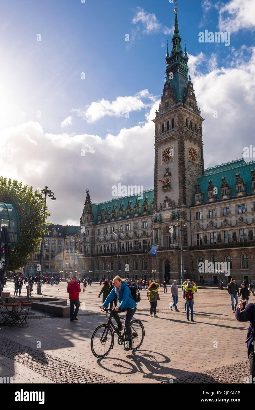 neo-Renaissance town hall with cyclist and people, Hamburg, Germany Stock Photo