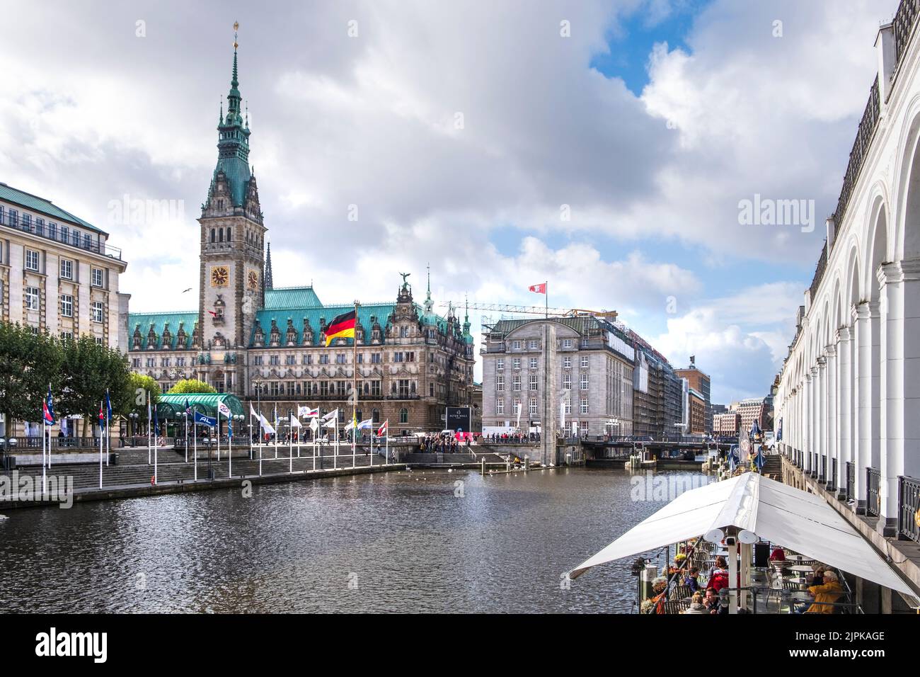 Alsterfleet canal from Alsterarkaden Shopping area looking towards City Hall with cafe in autumn, Hamburg, Germany Stock Photo