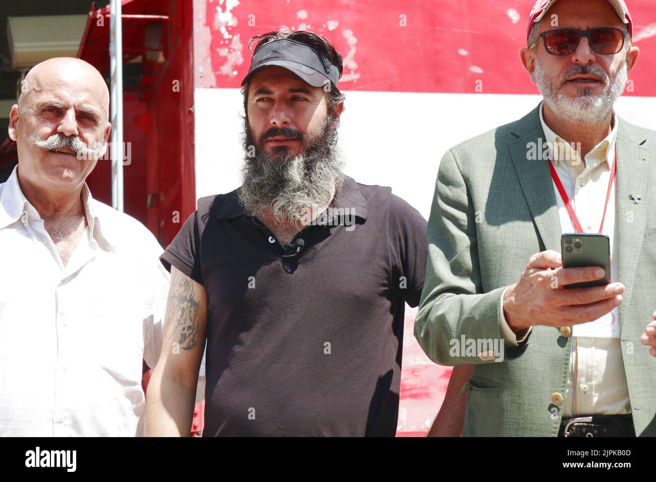 Bank assailant Bassam al-Sheikh Hussein poses with fellow depositor (left)  and lawyer Rami Ollaik (right) in Beirut, Lebanon, on August 18 2022. On  August 11 al-Sheikh entered the Federal Bank in Hamra