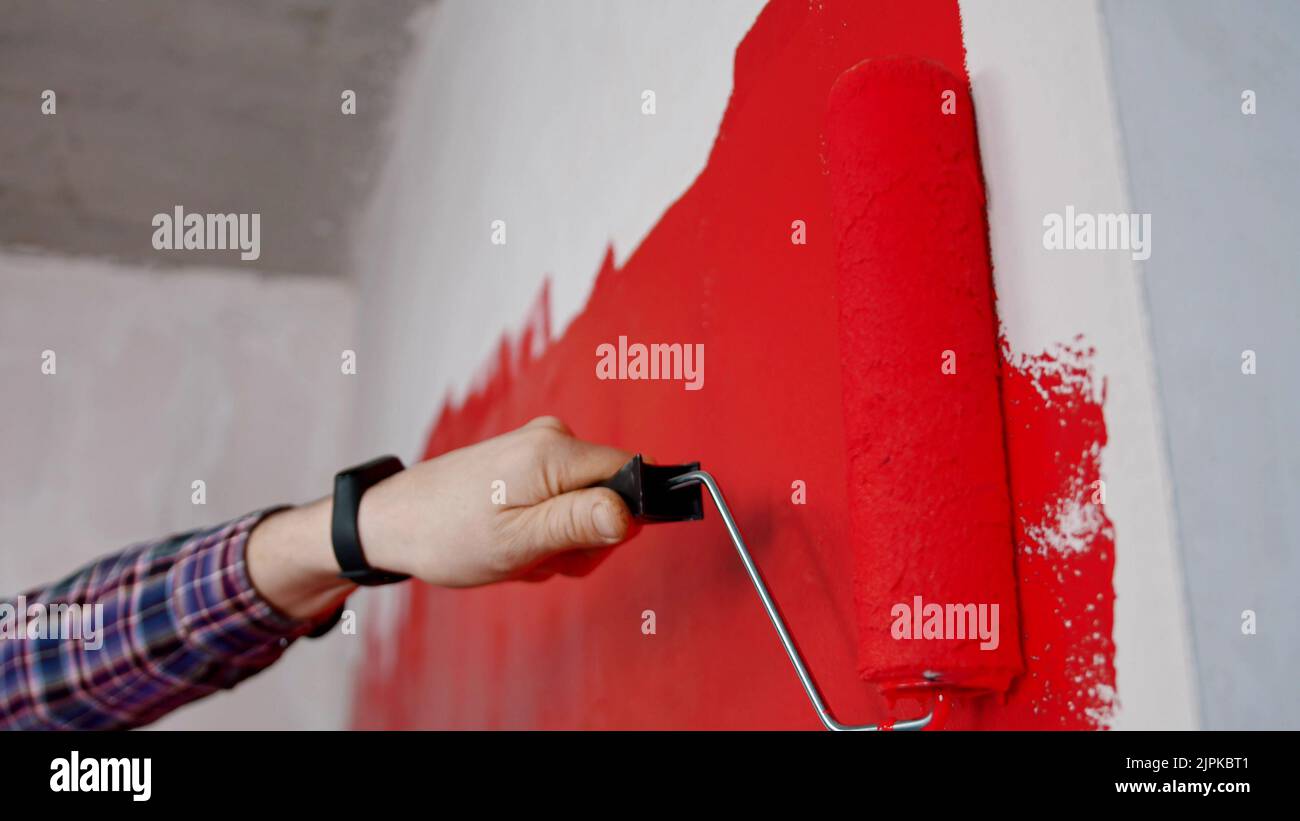 Covering wall in red paint in new apartment Stock Photo