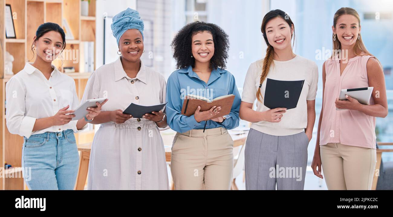 Team of female digital marketing or social media planners working in a creative agency for online seo or website design. Portrait of empowering women Stock Photo