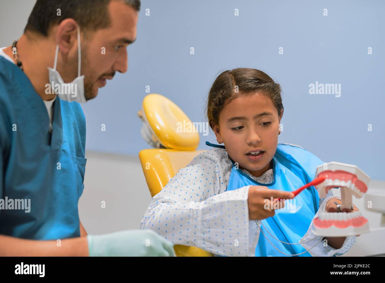Learning how to brush teeth the right way. a focused young male dentist