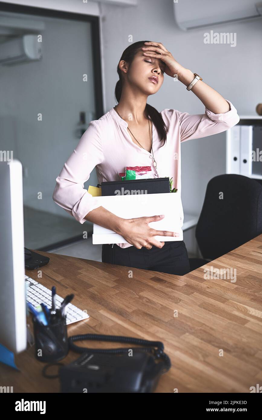 What will i do now an unhappy businesswoman holding her box of