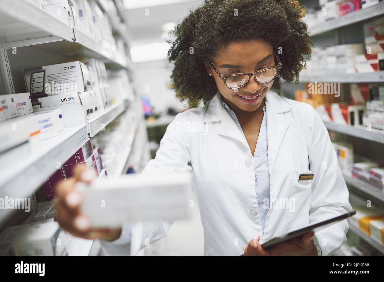 Ive been looking for this a cheerful young female pharmacist checking