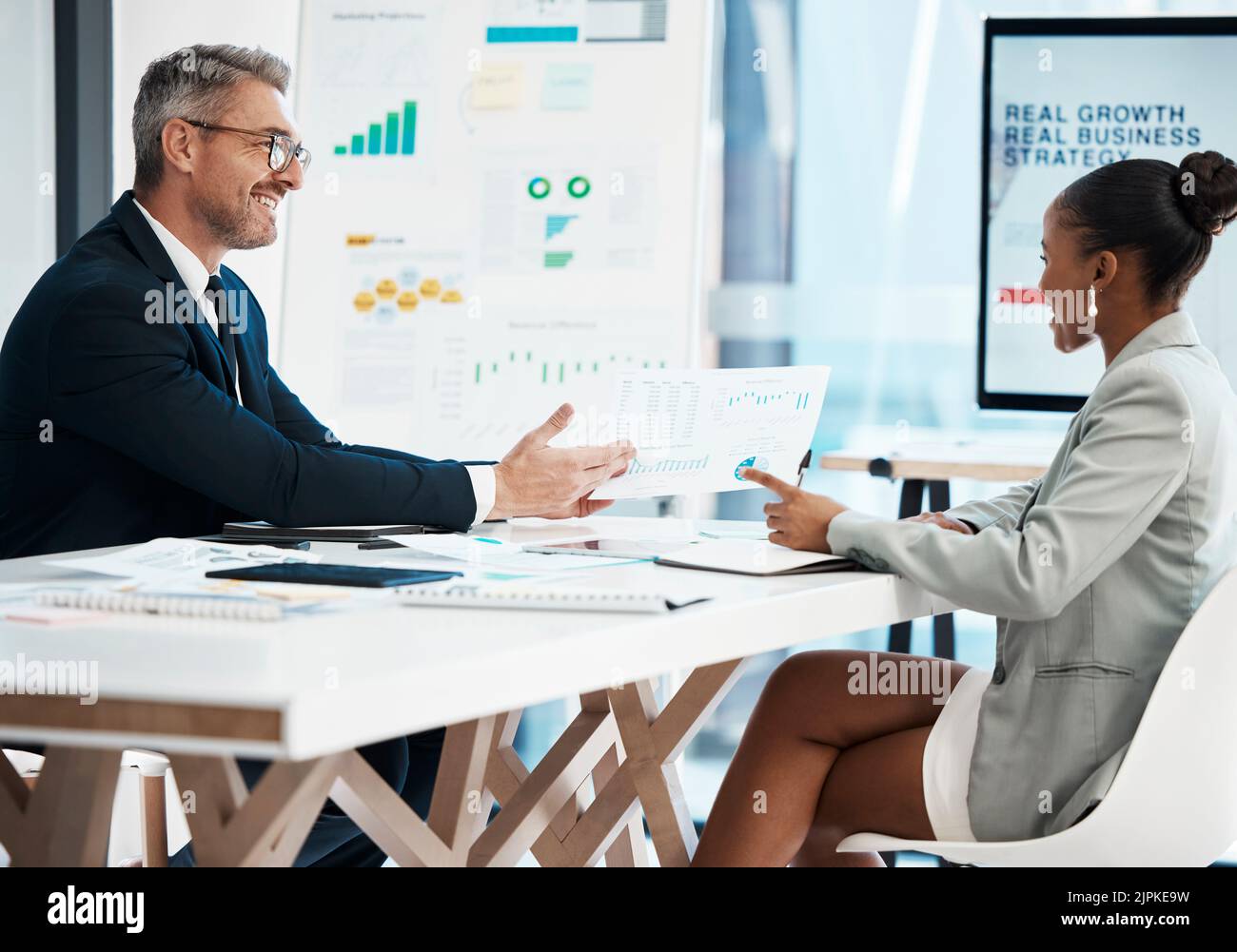 Business analyst, financial advisor and stock trader planning strategy, report and idea with graph, data and information during meeting in office Stock Photo