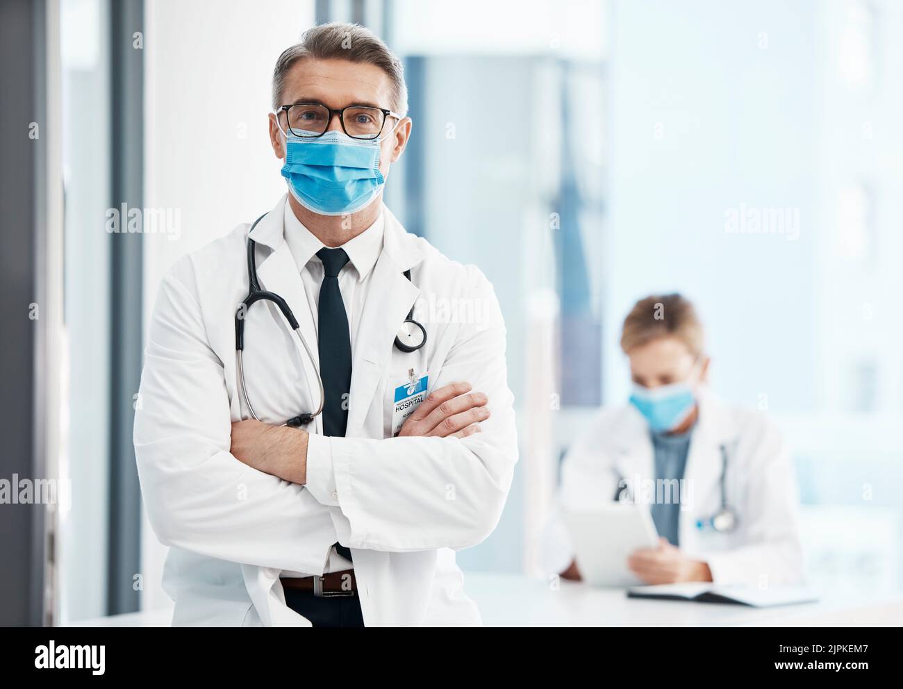 Doctor, physician or healthcare professional with covid face mask in a