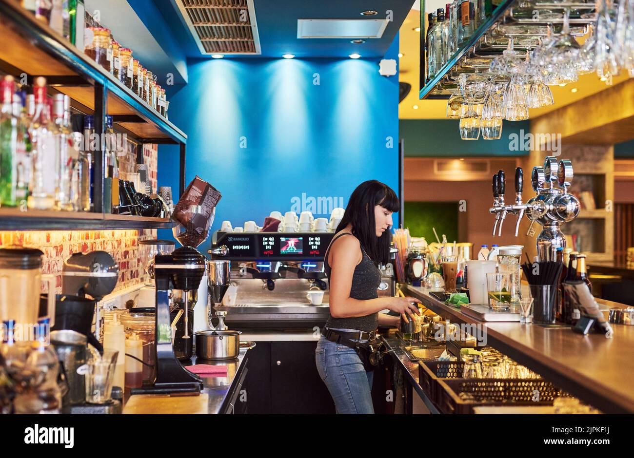 What she enjoys most. a young waitress working behind the counter at a