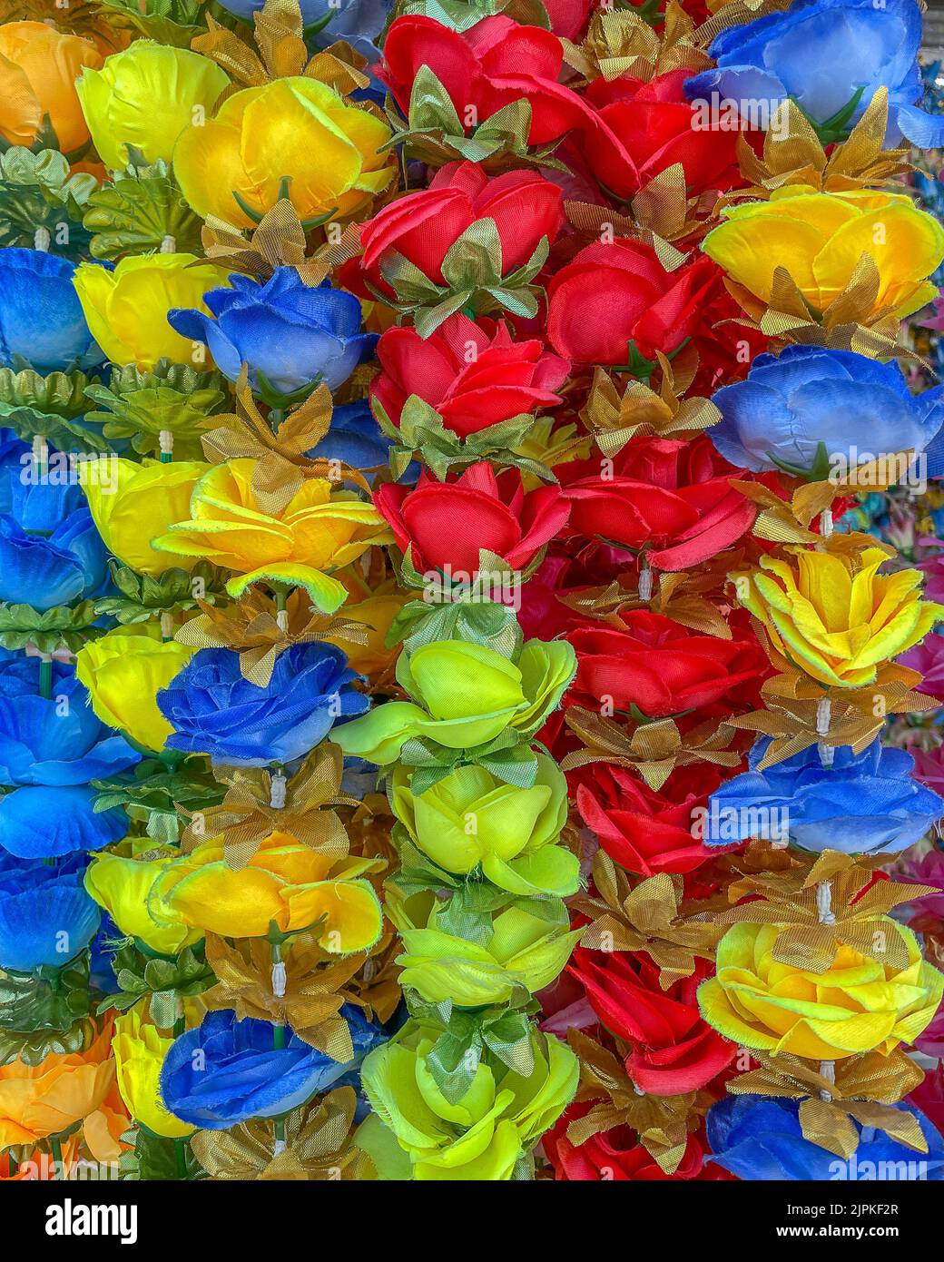 Close up of blue, yellow, and red cloth flowers. Stock Photo
