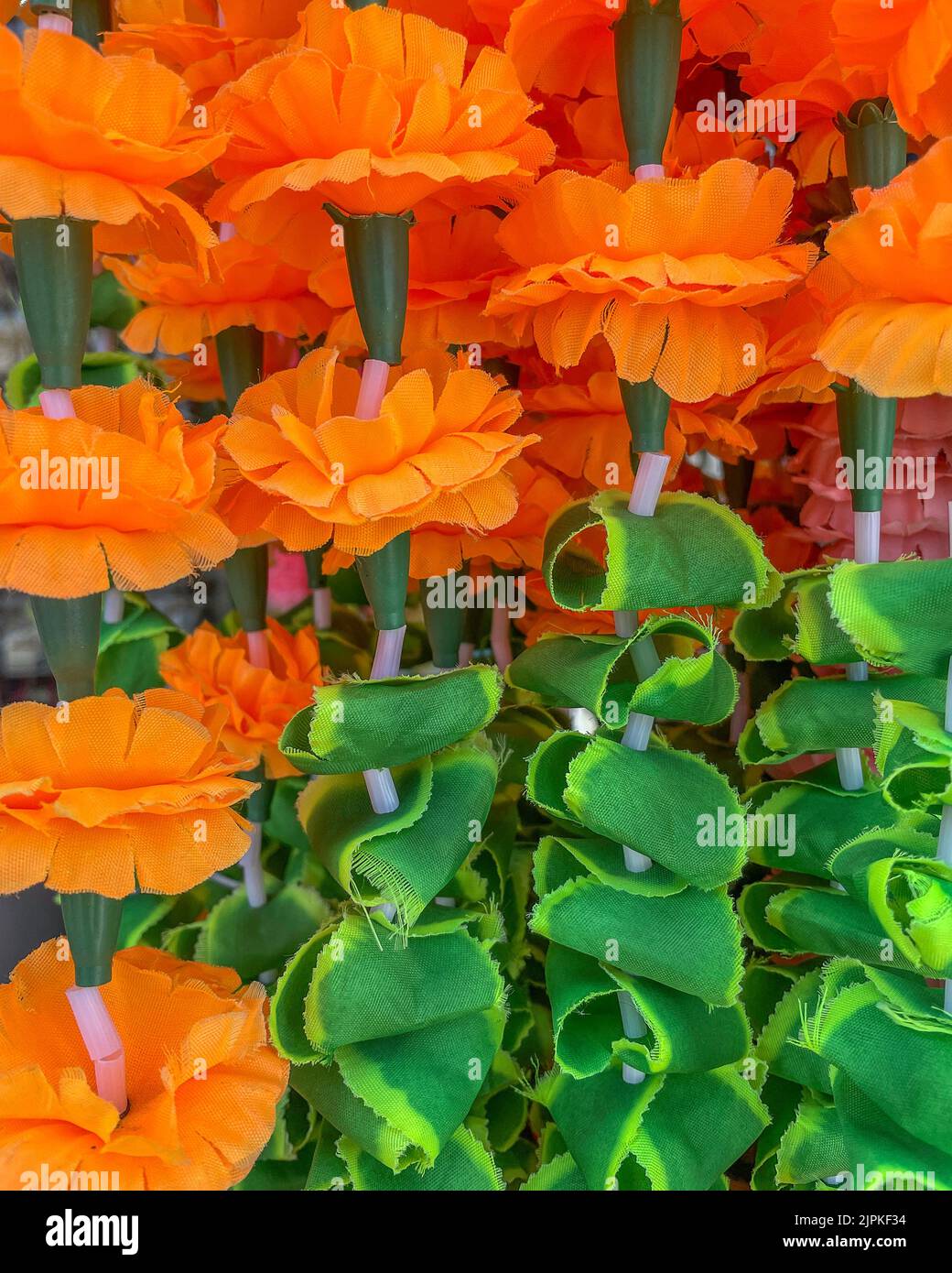 Close up of orange and green cloth flowers. Stock Photo