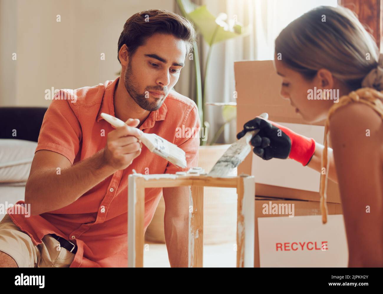 Couple painting or decorate wooden table or chair by recycle and thrift furniture for a home improvement project in apartment. Creative and DIY man Stock Photo