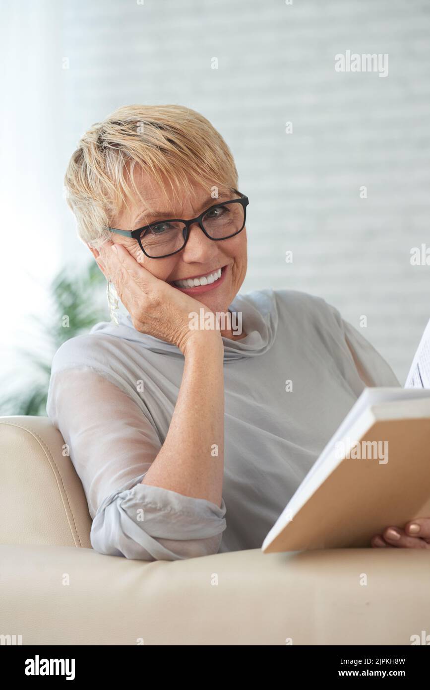 Pretty aged smiling woman with a book Stock Photo