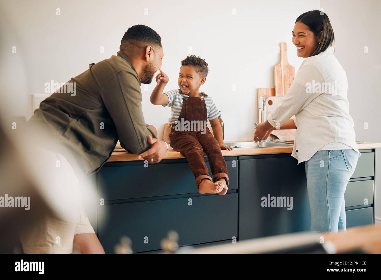 Parents, child and home of a fun, loving and caring family being playful with their son. Funny father making silly faces with his boy while having a Stock Photo