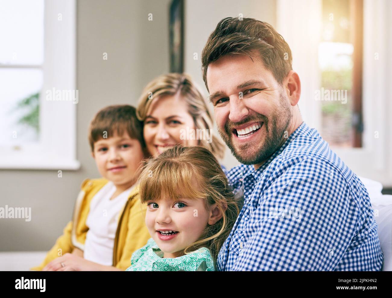We all about love and happiness. a family sitting on the sofa at home. Stock Photo