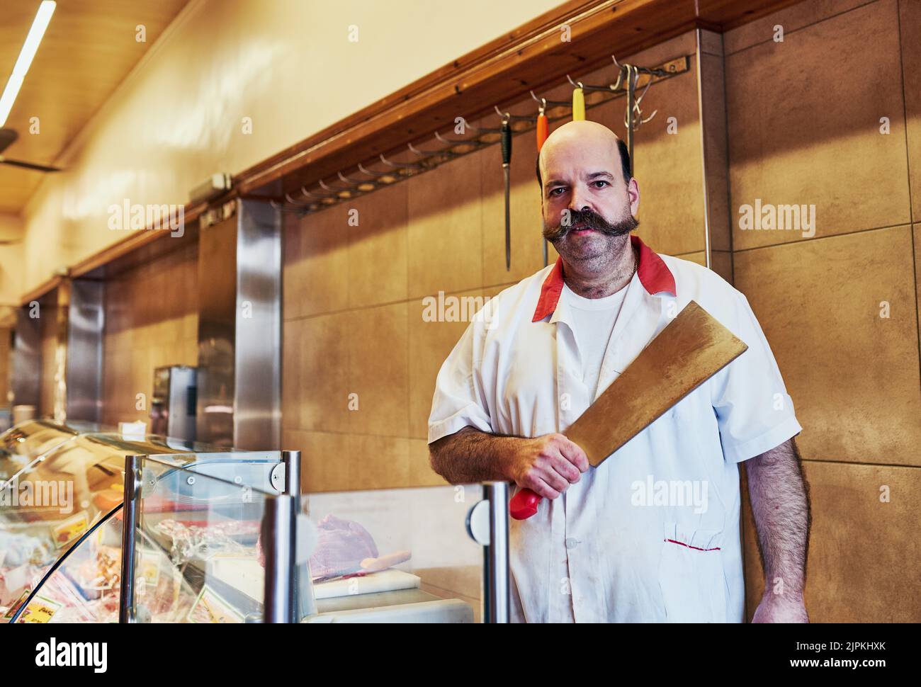 Ive got what I need to start the working day. a butcher at his store. Stock Photo
