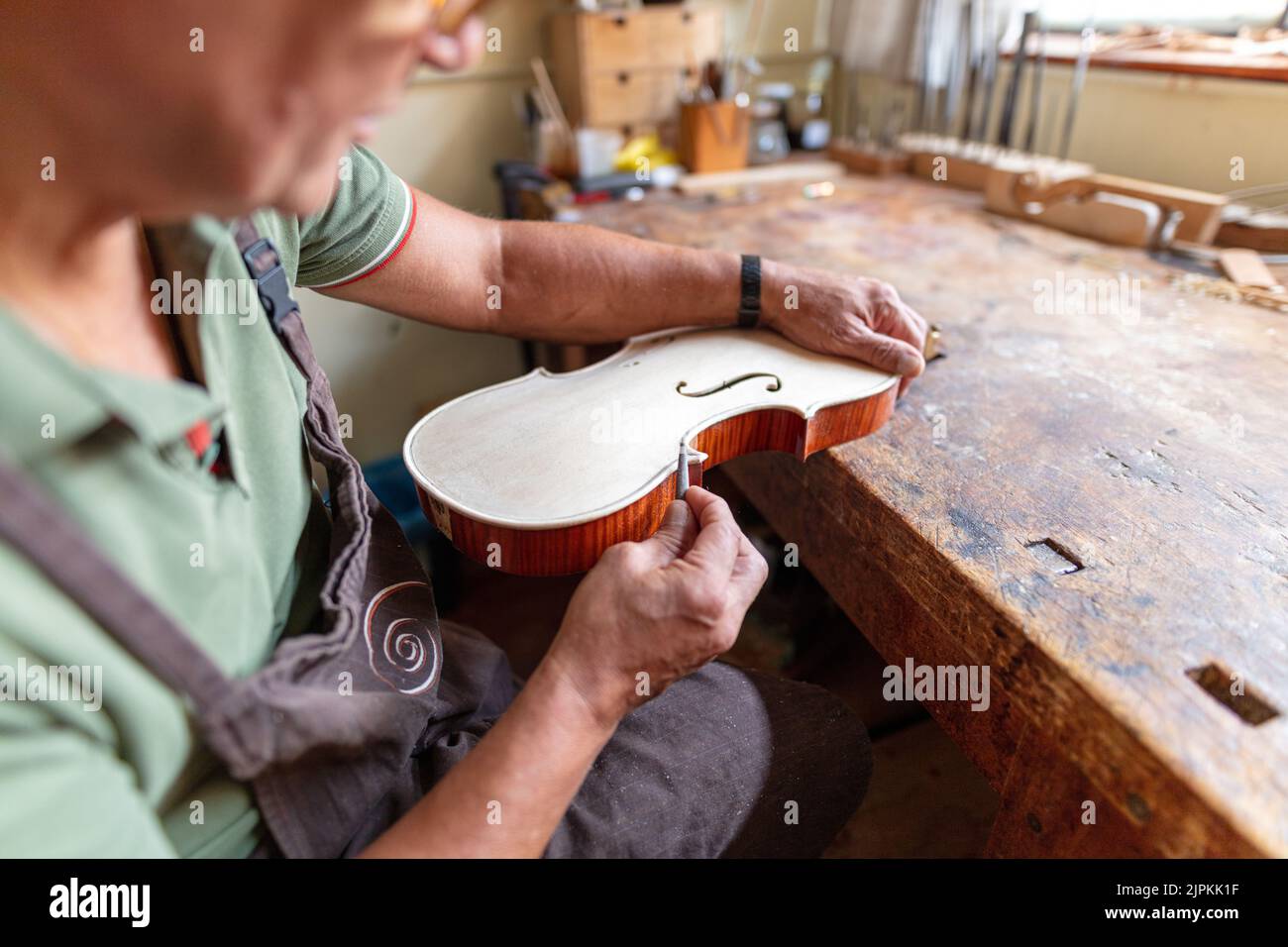 violinmaker at work in his italian workshop Stock Photo