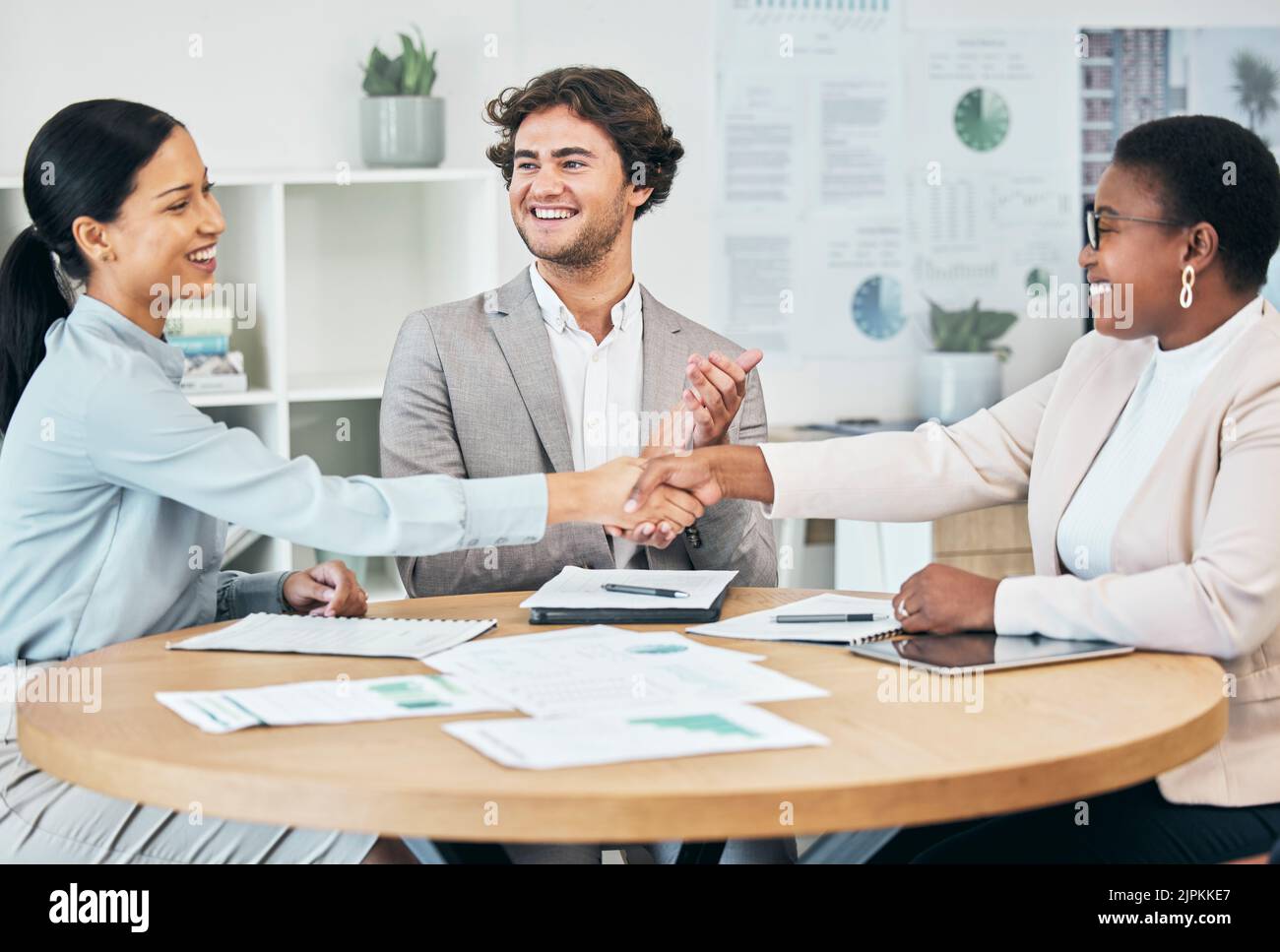 Happy business people do handshake in agreement, congratulate and teamwork in office meeting after successful partnership deal with colleague clapping Stock Photo