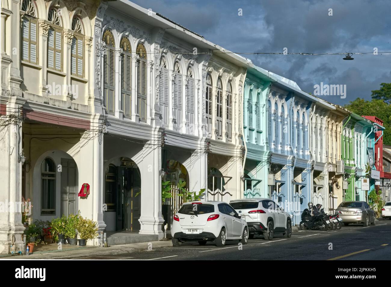 A row of differently coloured Sino-Portuguese or Peranakan houses in Dibuk Road in the Old Town heritage area of Phuket Town, Phuket, Thailand Stock Photo
