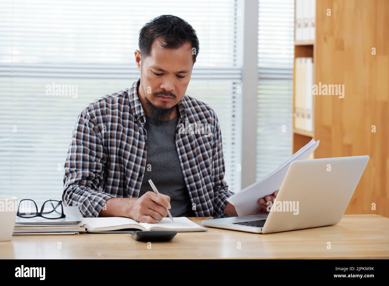 Businessman working with documents and taking notes Stock Photo