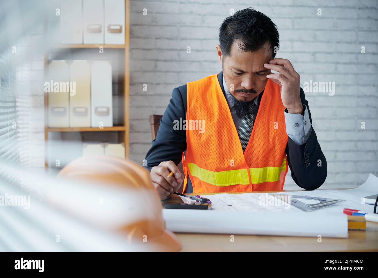 Pensive professional architect working on housing project Stock Photo