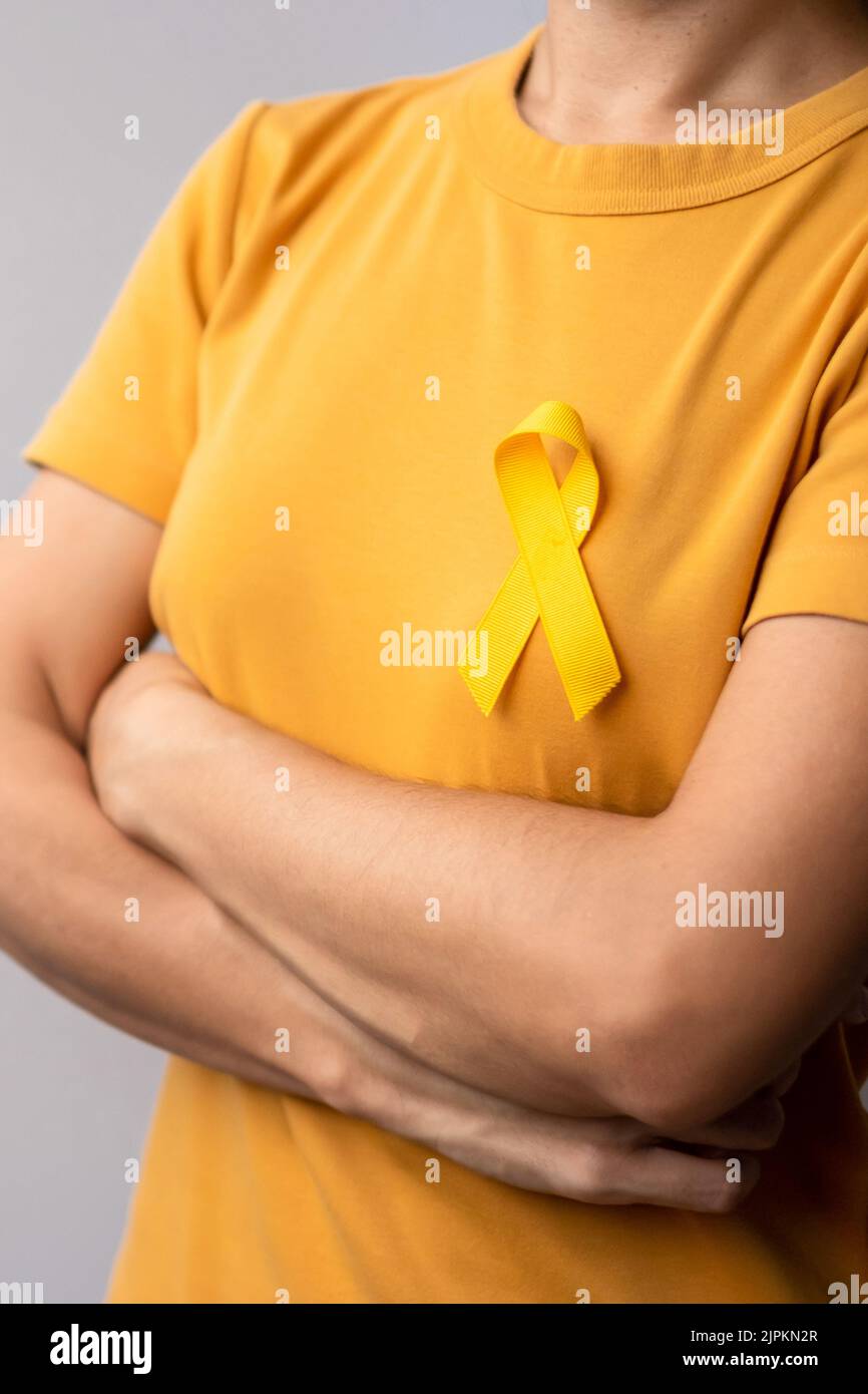 Suicide prevention day, Childhood, Sarcoma, bone and bladder cancer Awareness month, Yellow Ribbon for supporting people life and illness. Healthcare Stock Photo