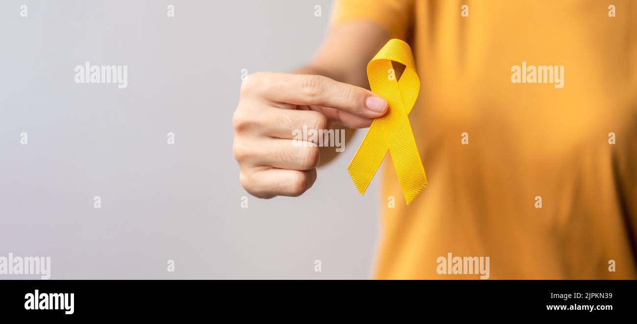 Suicide prevention day, Childhood, Sarcoma, bone and bladder cancer Awareness month, Yellow Ribbon for supporting people life and illness. Healthcare Stock Photo