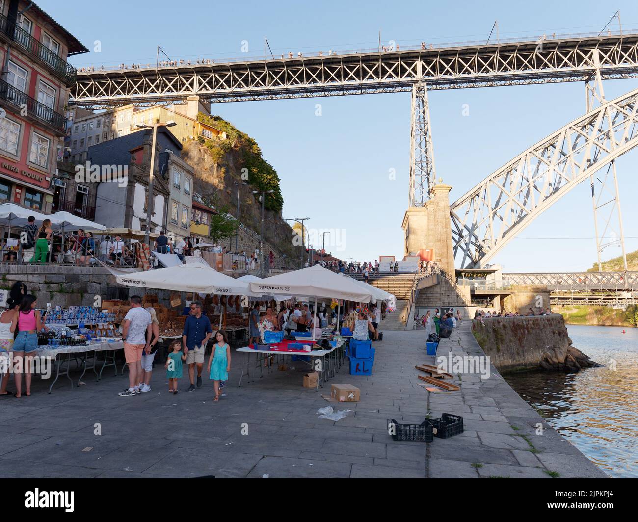 Market stalls in the Ribeira aka Riverside district of Porto, Portugal with the Douro River and Luis I bridge. Stock Photo