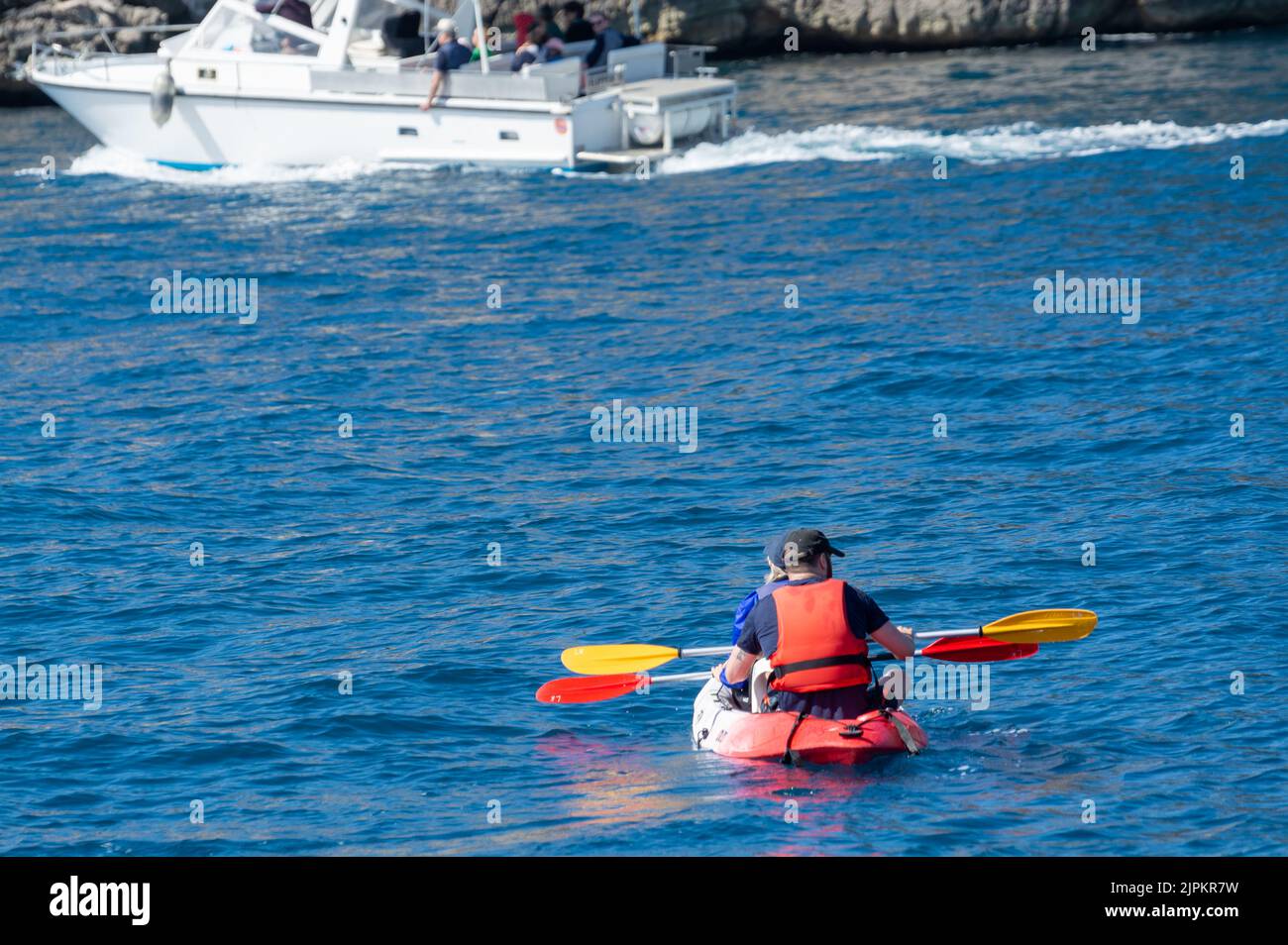 Unidentified two sporters in kayak is Calanque de PortMiou near Cassis, excursion to Calanques