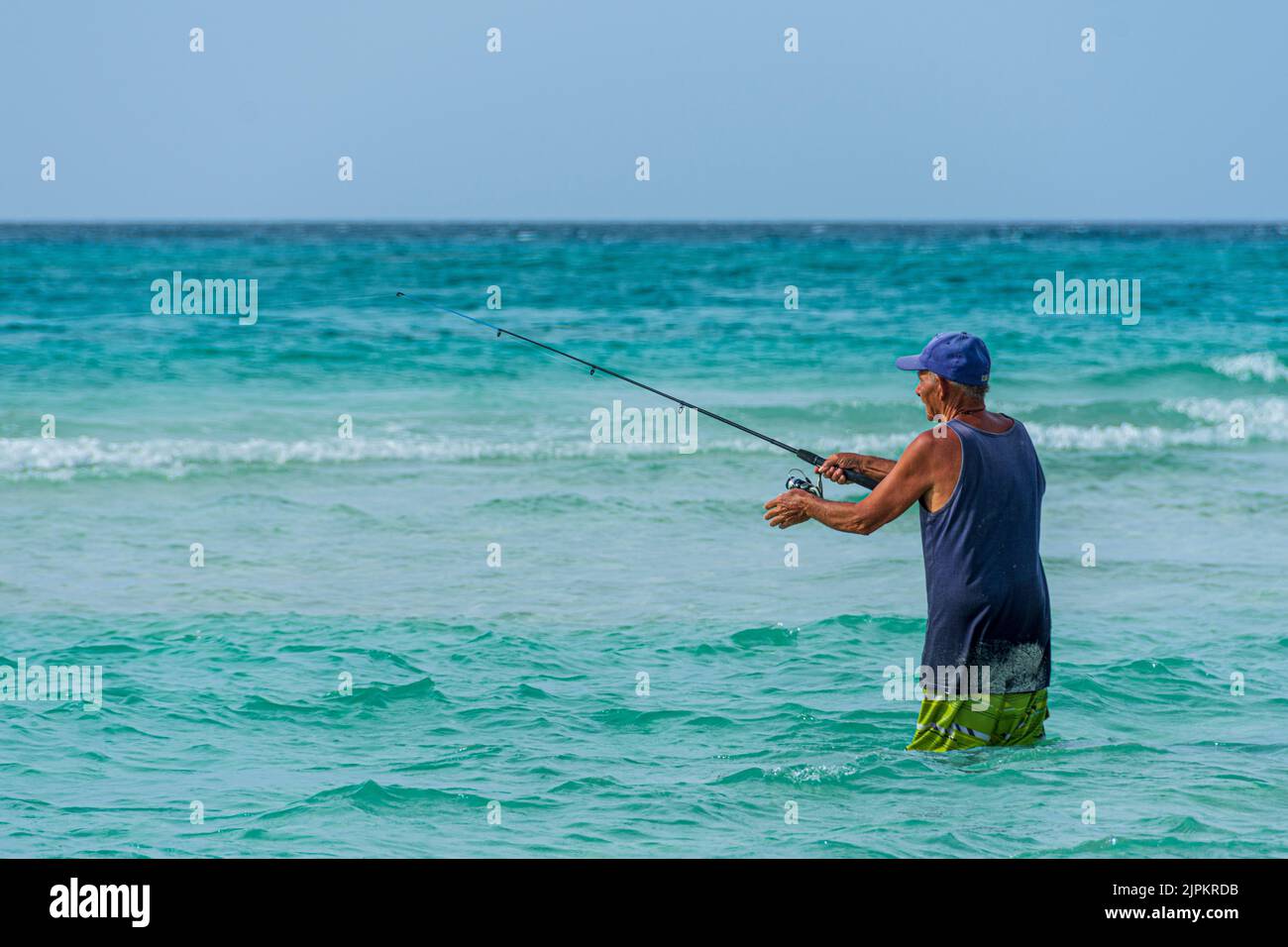 A middle-aged, Cuban man shore fishing, Varadero Beach, Cuba. Stock Photo