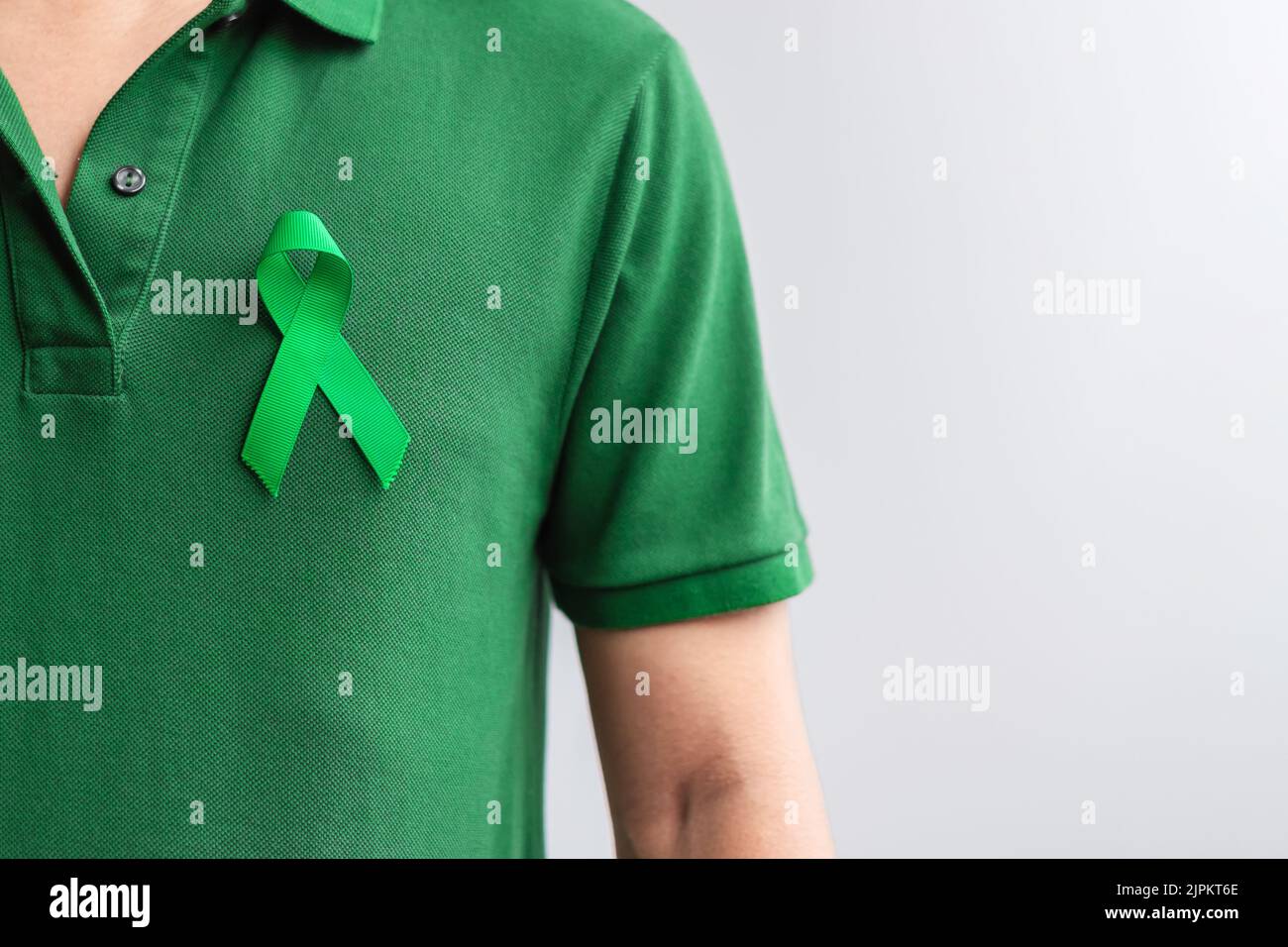 green Ribbon for Liver, Gallbladders, bile duct, cervical, kidney Cancer and Lymphoma Awareness month. Healthcare and world cancer day concept Stock Photo