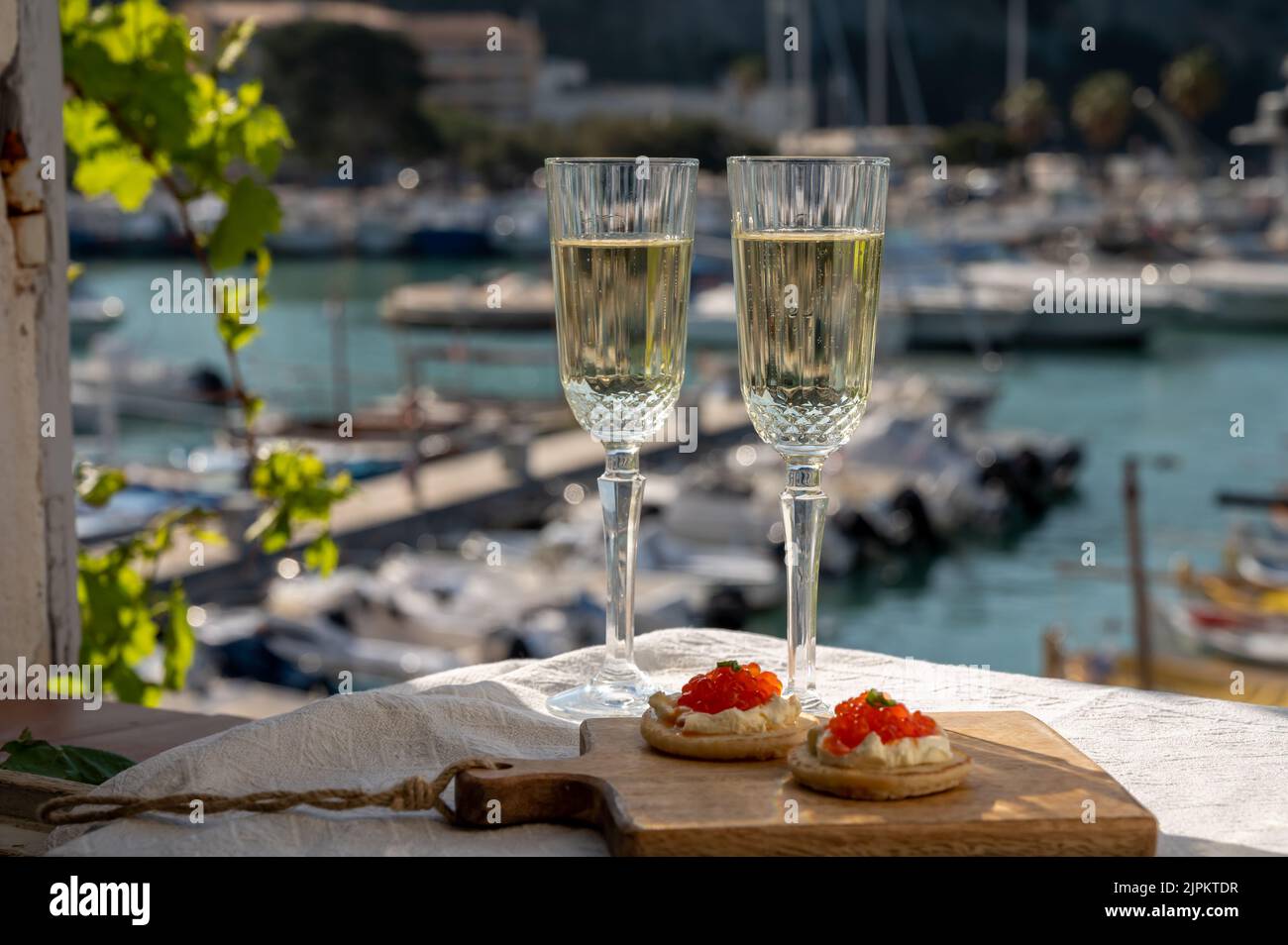 Pairing of small blinis with sour cream and salted salmon red caviar ...