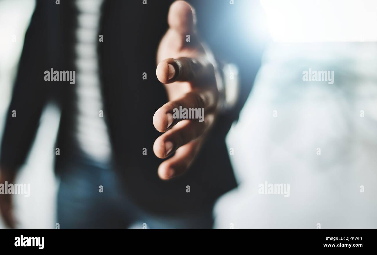 Handshake, welcome and greeting with a business man reaching out his hand to congratulate, promote or celebrate success. Closeup of teamwork, unity Stock Photo