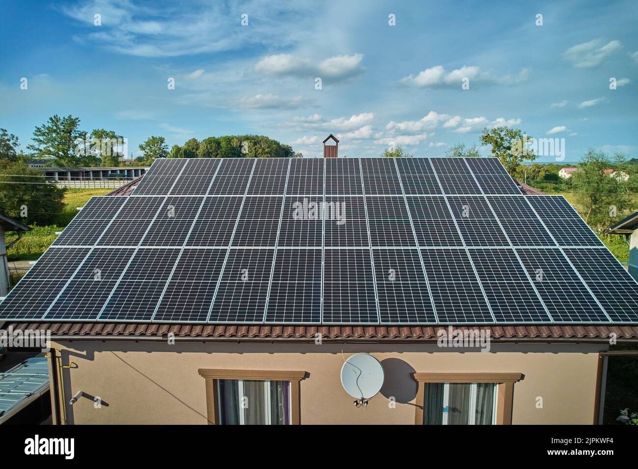 Aerial top view of new modern house cottage with solar photovoltaic