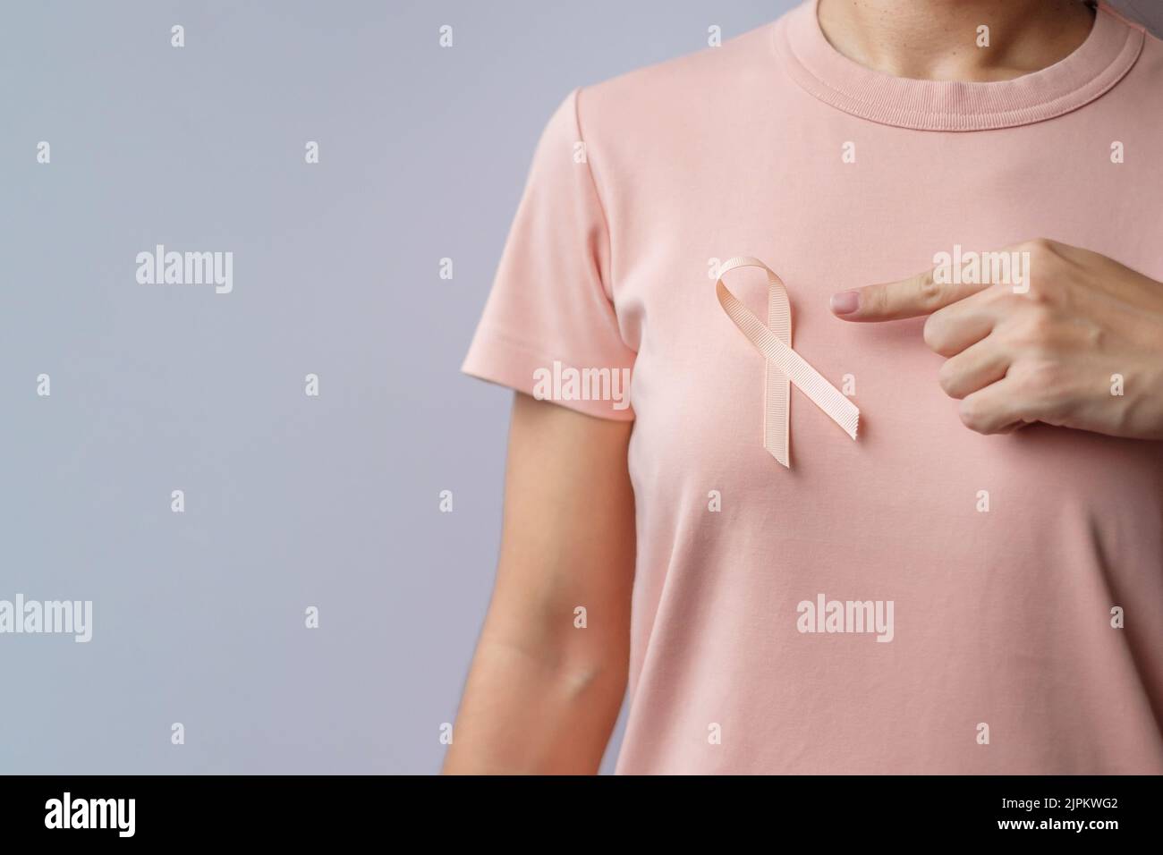woman hand holding Peach Ribbon for September Uterine Cancer Awareness ...