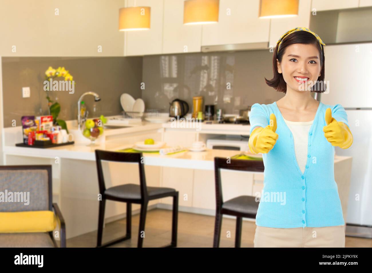 Happy Vietnamese housewife in rubber gloves showing thumbsup Stock Photo Alamy