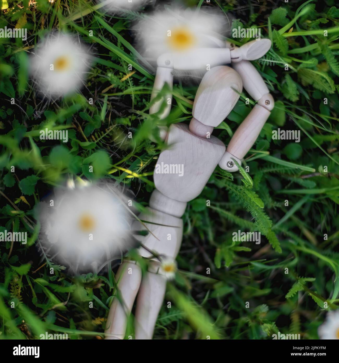 mannequin lying relaxed in the lawn Stock Photo
