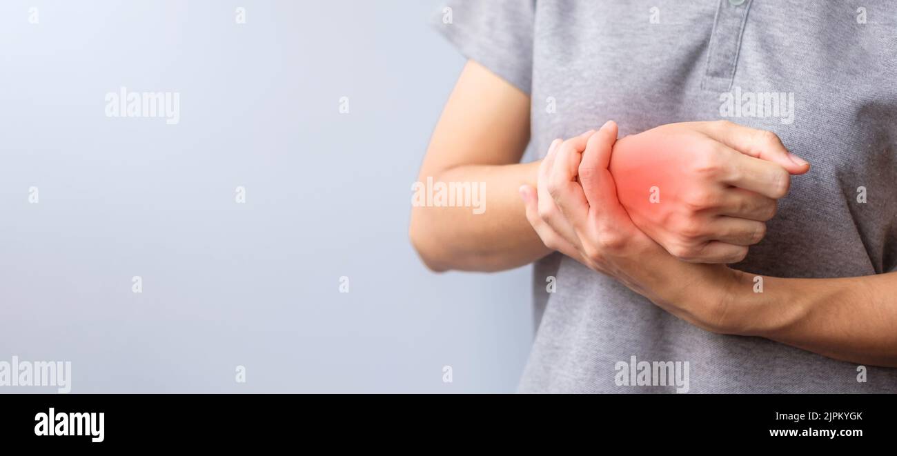 woman holding her wrist pain because using smartphone or computer long