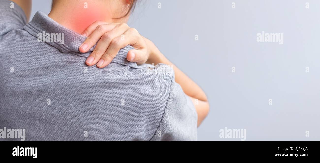 woman with her neck sprain, muscle painful during overwork. Girl having body problem after wake up. Stiff neck, office syndrome and ergonomic concept Stock Photo