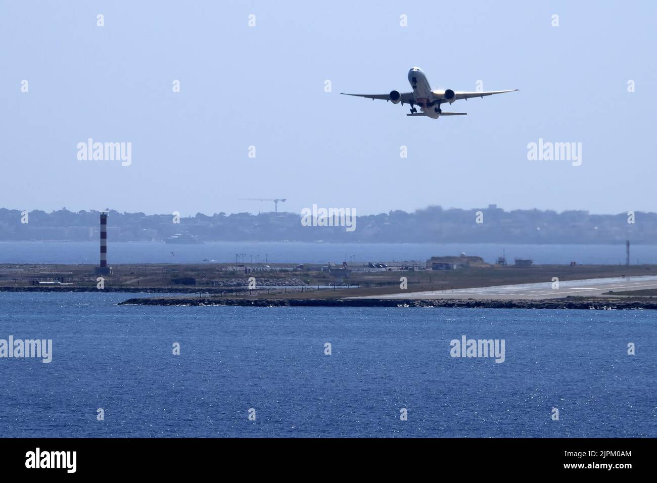 Airplane While Taking Off From Nice France Airport By The Sea Stock Airplane while taking off from nice france airport by the sea stock