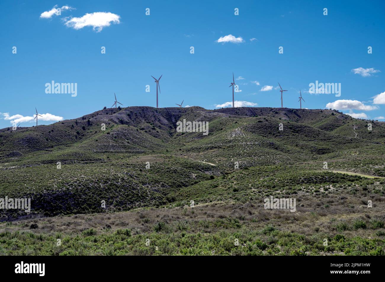 The wind turbines on the hills under blue sky Stock Photo - Alamy