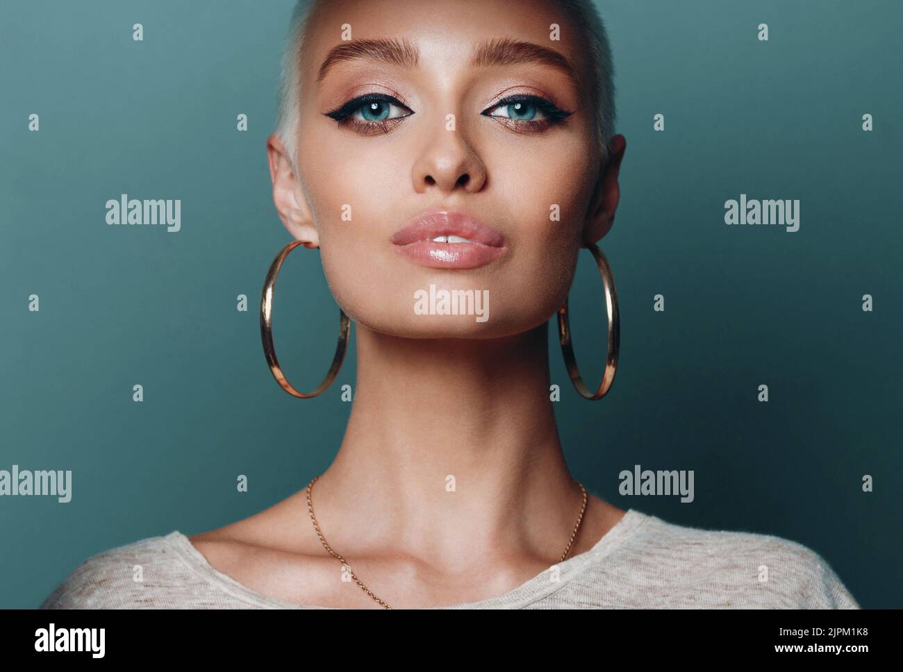 Gold earring hi-res stock photography and images - Alamy