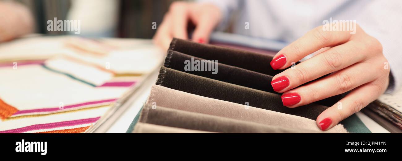 Woman chooses fabric in furniture store closeup Stock Photo