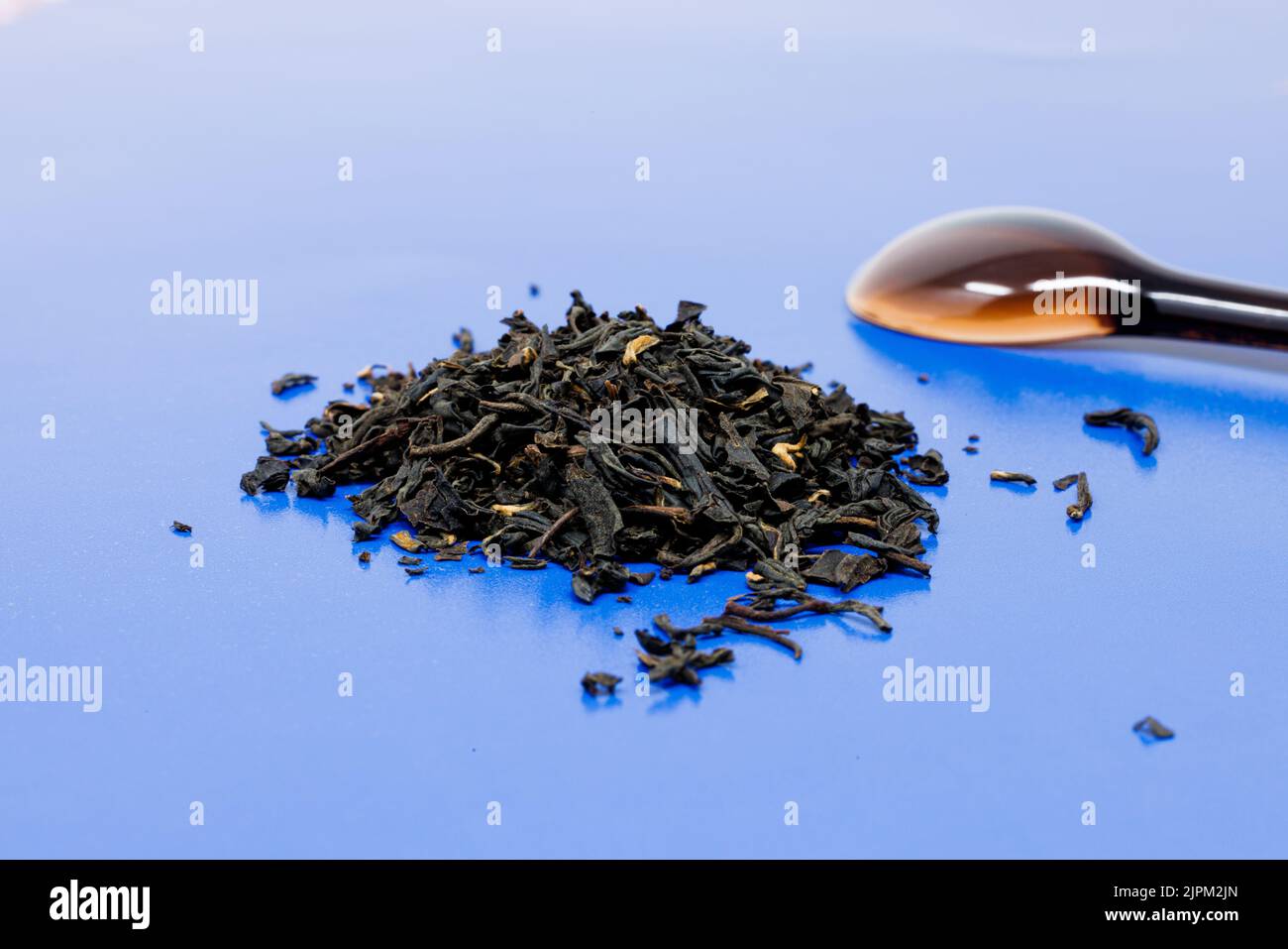 The dried black tea leaves on a blue surface Stock Photo Alamy