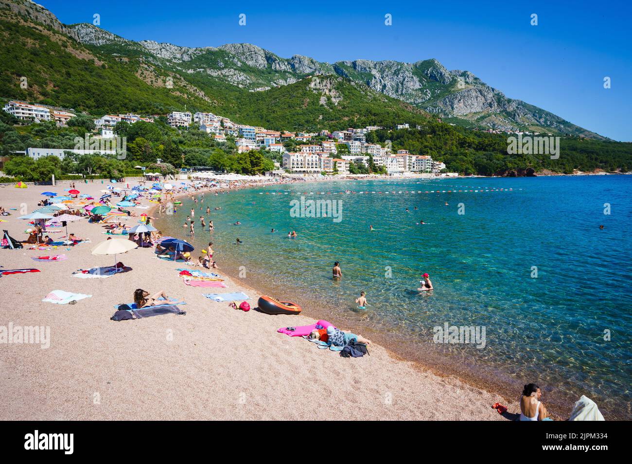 People relaxing on a beach on a hot day near Sveti Stefan, Montenegro. Stock Photo