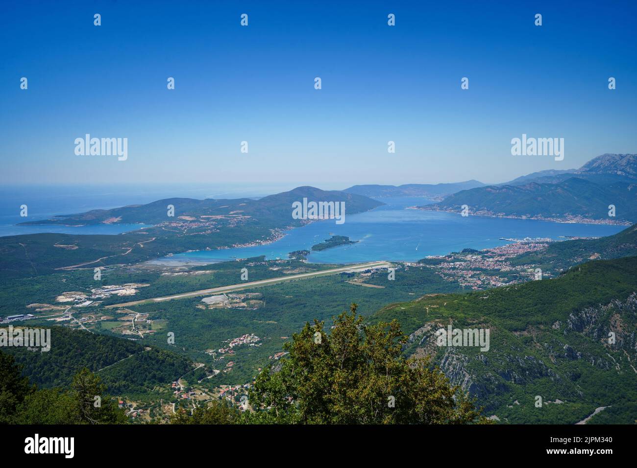 View over Tivat and Tivat Airport near Kotor, Montenegro from Serpentines on a clear, cloudless day near Trojica Observation Deck. Stock Photo